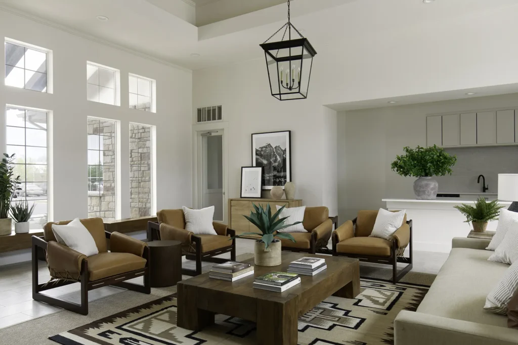 Community lounge with sofas and chairs around a fireplace and TV