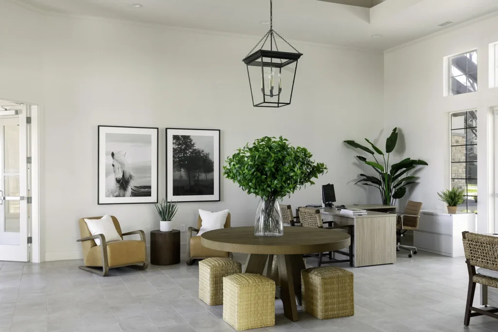 Leasing office lobby with arm chairs and tables