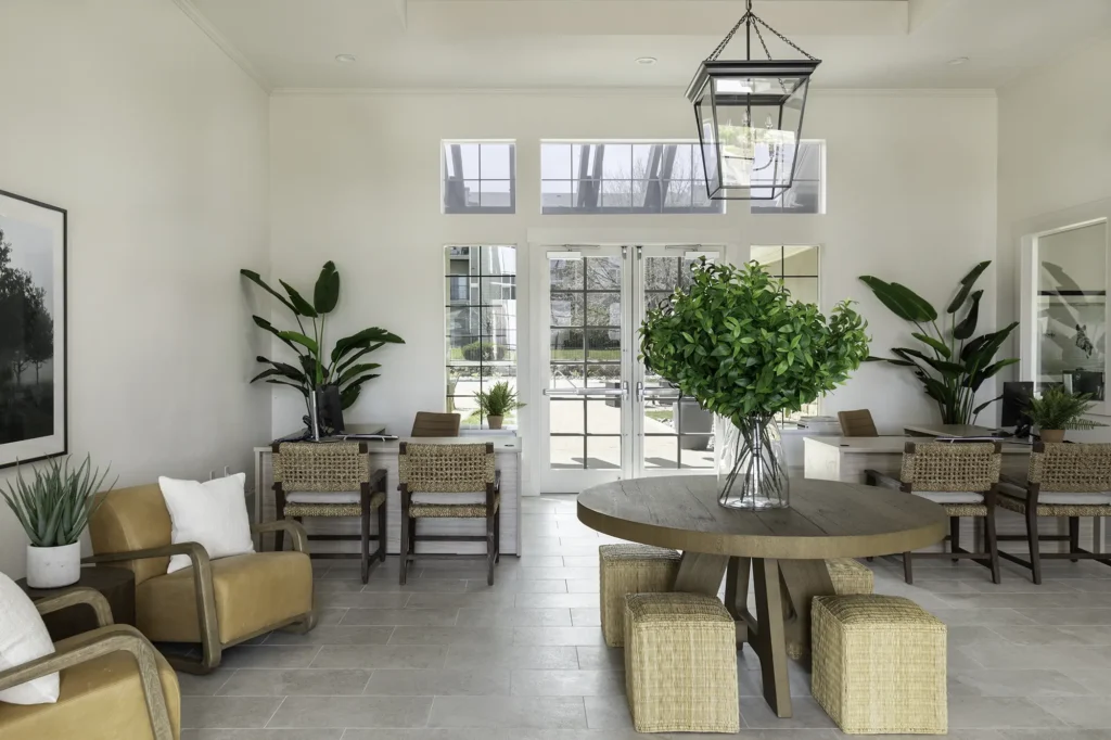 Leasing office lobby with arm chairs and tables